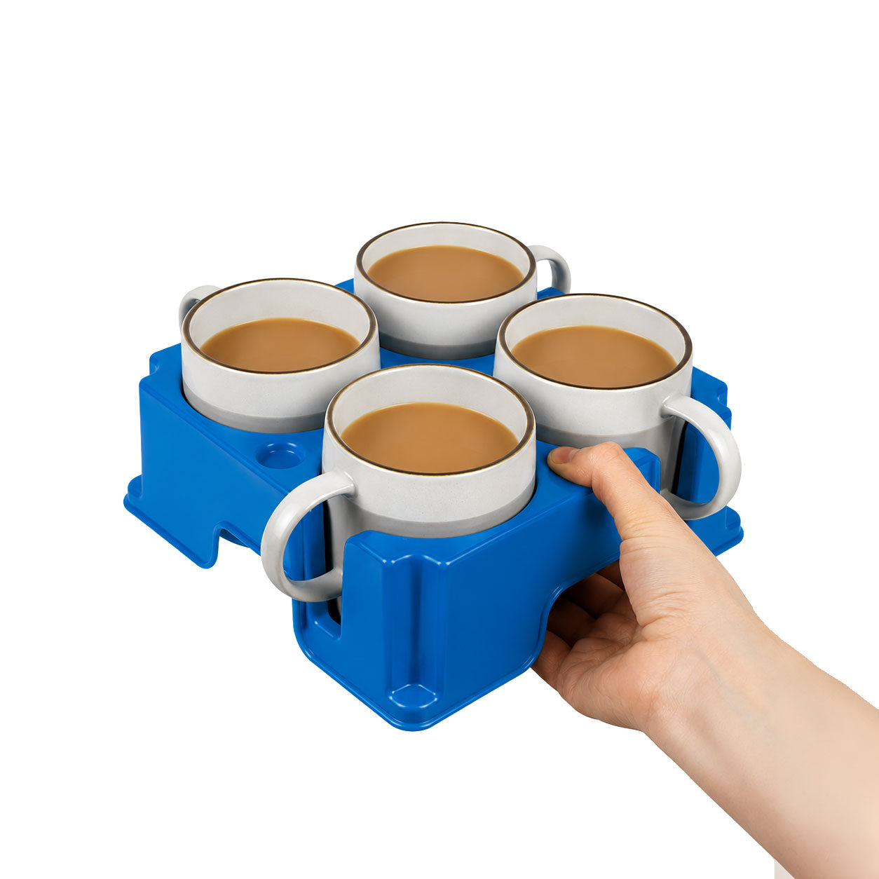 Hand holding a blue muggi carrier with four white mugs filled with a brown liquid on a white background
